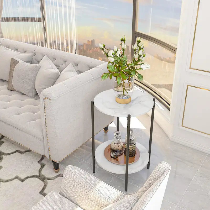 Table d'appoint ronde à deux niveaux en marbre, structure en métal noir.